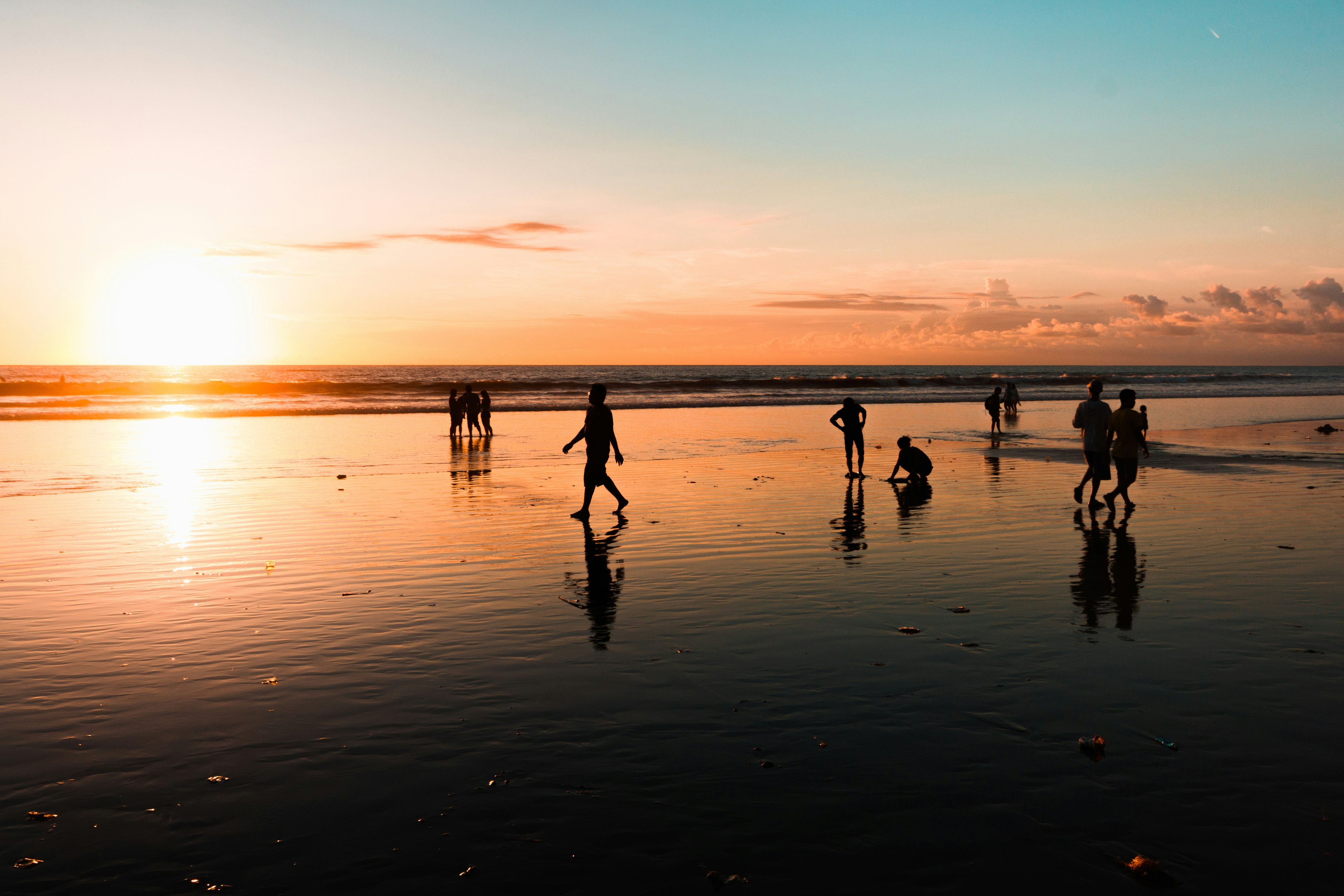 people at the beach during golden hour